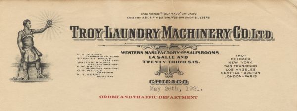 Letterhead of the Troy Laundry Machinery Company, with a classical figure of a man wearing a work apron and caligae, holding in his right hand a hammer, and with his left hand holding aloft a shining disc emblazoned with the company initials, TLMC, as well as the slogan: "Honest Construction, Best Value."