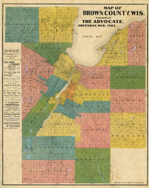 Map of Brown County, Wisconsin, shows the township and range grid, towns, sections, cities, villages and post offices, land owners and acreages, railroads, roads, rural postal routes, schools, churches, cemeteries, and lakes and streams. Advertisements are printed in the left-hand margin.