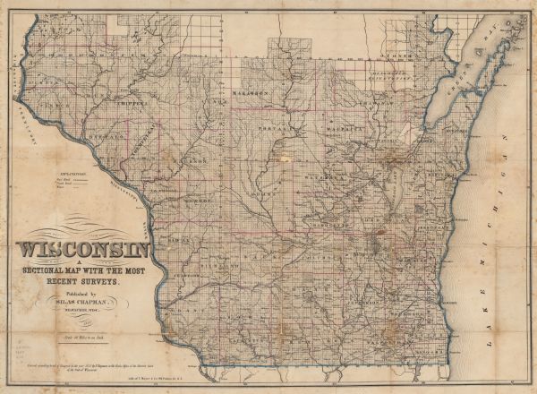 This map shows the township survey grid and identifies counties, named towns, rivers, lakes, railroads, plank roads, mines, and the Menomonee Reservation. Horicon Marsh is labeled Lake Horicon.
