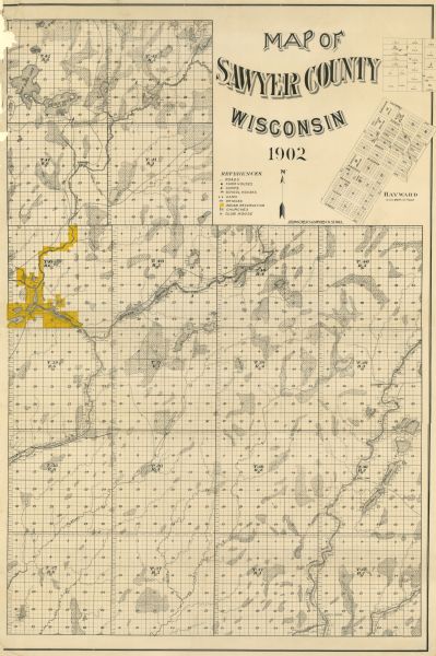 This 1902 map of the eastern portion of Sawyer County, Wisconsin, shows the township and range system, sections, roads, farm houses, camps, school houses, dams, bridges, the Indian reservation, churches, and wetlands, lakes and streams. An inset map of Hayward is also shown. Shows roads, farm houses, camps, school houses, dams, bridges, Indian reservation, churches, and club house.