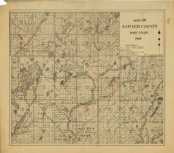 This 1919 map of Sawyer County, Wisconsin, shows the township and range system, sections, cities and villages, roads, railroads, farm houses, the Indian reservation, and wetlands, lakes and streams.