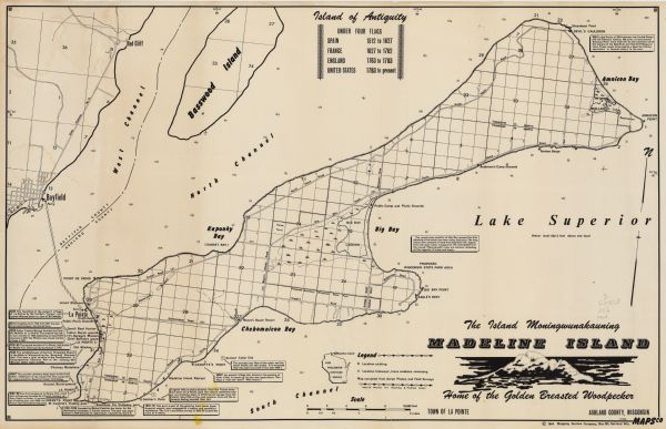 This 1964 map of Madeline Island, Ashland County, Wisconsin, shows existing and historical locations, roads, the boundaries of a proposed state park, sections, and wetlands. Text provides information on historical sites and events. Also includes Basswood Island.
