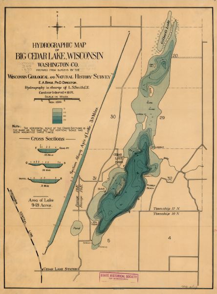 This 1899 map shows the contour depths of Big Cedar Lake in Washington County, Wisconsin, and includes four cross sections of the lake. Roads, railroads, springs, and wetlands in the area are shown.