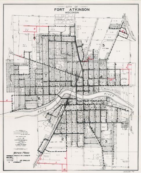 Lower left hand corner features a legend. "Drawn 1938, revised 1947." Shows water mains, hydrants, corporation limits, city ward divisions, fire proof building limits, local streets, and part of Rock River. Includes manuscript annotations in red.