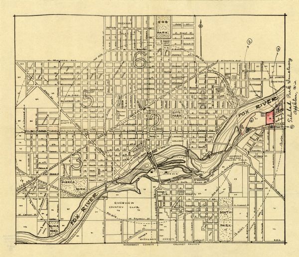 Map shows street map with wards numbered, the Fox River, railroads, playgrounds, cemeteries, and schools. The map also includes a manuscript annotation indicating location of Telulah Park Sanctuary. The lower right margin reads: "R.M.C." The bottom of shows the break between Winnebago county and Calumet County.