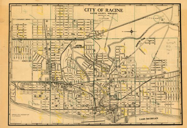 This map of Racine is oriented with north to the right and shows labeled streets, Lake Michigan, and points of interest. There are manuscript annotations in yellow and green pencil. The back of the map is an index of churches, schools, public buildings, business houses and factories, and streets.
