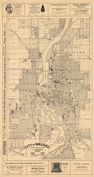 This map is mounted on cloth and shows lots and landownership, selected buildings, roads, railroads, parks, cemeteries, city wards, and includes advertisements in the margins.