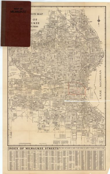 This map is attached to a cover. Streets, points of interest, the Milwaukee River, and Lake Michigan are labeled. The bottom margin of the map includes a street index. A section of downtown located on the middle right of the map has been trimmed off and marked with manuscript annotations in red showing churches.