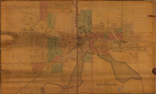 This map shows lot and block numbers and dimensions, landownership, city wards, buildings, streets, railroads, parks, cemeteries, churches, schools, and industrial buildings.

