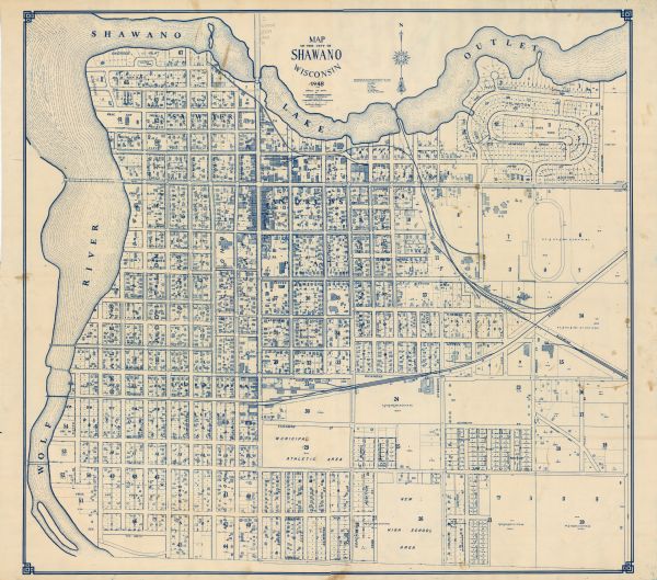 This blue line print map shows lot and block numbers and dimensions, buildings, streets, railroads, and the Wolf River.

