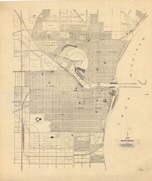 This plat map shows numbered blocks and lots, wards, local streets, railroads, cemeteries, buildings, land ownership by name, and parts of Manitowoc River and Lake Michigan.