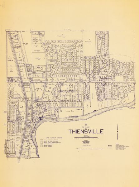 This blue line print map shows zone districts, lot and block numbers and dimensions, building setbacks, center lines of streets, and some landownership. The Milwaukee River is labeled. The bottom left of the map includes a zone district legend and the bottom right of map has a legend. The map reads: "While we believe this map to be correct in every respect, its accuracy is not guaranteed."