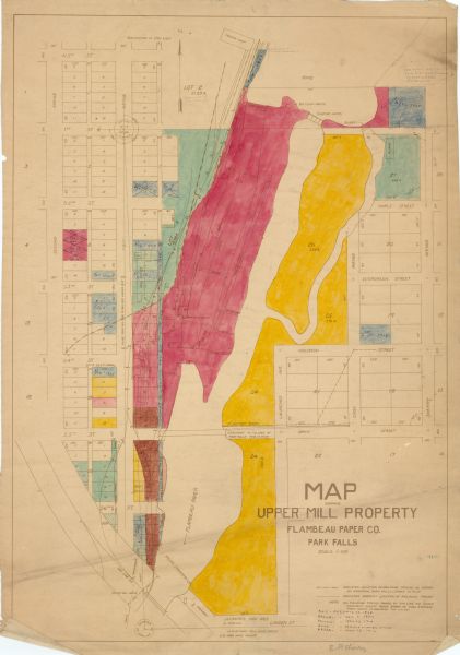 This map shows buildings, lots, utilities, and original plat and present locations of railroads. Portions of the map are shown in red, brown, yellow, blue, and green, and a hand written annotation in the lower right corner provides a key of the colors. Streets and the Flambeau River are labeled.