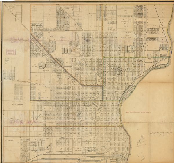 This map shows wards, roads, railroads, lot and block numbers, subdivisions, parks, some landownership, and a race course. Manuscript annotations in red ink show the location of stone monuments.