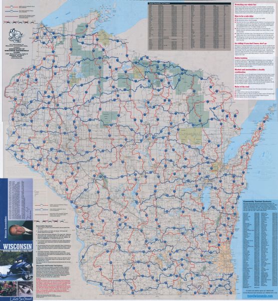 The front of map shows trails throughout the bottom half of Wisconsin and includes text on snowmobile rules and tourism contacts. The reverse shows trails throughout the top half of Wisconsin and lists county snowmobile contacts and safety tips.