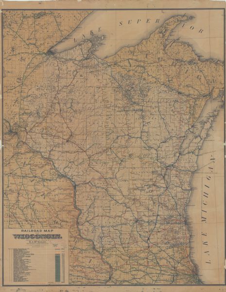 This map shows railroad routes in red, blue, orange, brown, pink, green, and dotted, as well as lakes, rivers, and communities. The map includes a legend in the lower left corner of railroad lines, with total mileage. Portions of Illinois, Iowa, Minnesota, and Michigan are visible.