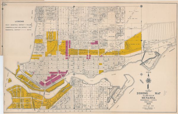 This map shows block and lot numbers, subdivisions, streets, railroads, and abandoned right of ways. Some areas are shown in yellow and pink. The city seal of Menasha is seen as the center of the compass in the the lower left corner. The upper left corner contains a legend. Little Lake Butte des Morts, the Fox River, and Lake Winnebago are labeled.