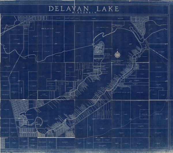 This blue line print shows land ownership by name, roads, and highways. The map includes manuscript annotations in pencil.