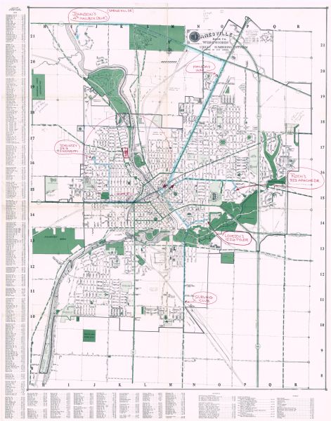 A street map of Janesville showing the block numbers on each street.  Other landmarks are labeled such as chain stores, parks, schools, manufacturing companies, hotels, arboretums, golf courses, Rock River, and car dealerships. Six places are marked in red pen: Curling Club, Lovejoy's 1526 Tyler, Roth's 323 Apache Dr., Holiday Inn, Johnson's 4th Mailbox, and Schlintz's 2313 Sinnissippi.
