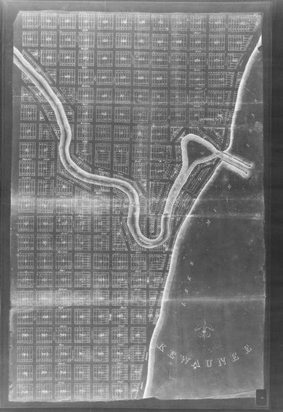 This photocopy map shows land parcels, block numbers, streets, the Kewaunee River, and Lake Michigan on the far right side. The original map was created around 1830.