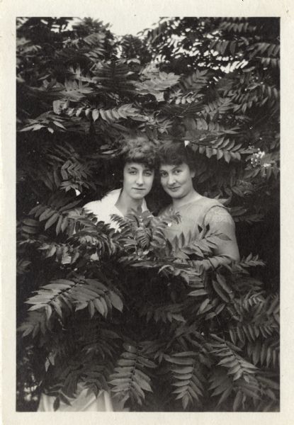 Francis Rodenschmidt Doyle and an unidentified woman pose together surrounded by sumac foliage.