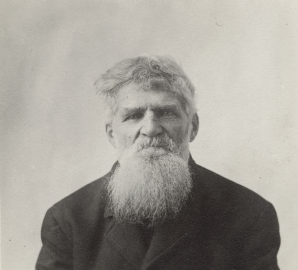 Quarter-length portrait of unidentified man with a beard and moustache. He is wearing a jacket.