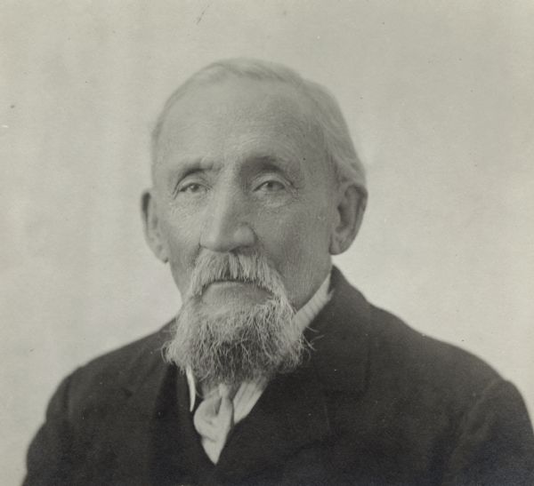Quarter-length portrait of unidentified man with a beard and moustache, wearing a jacket, shirt and tie.