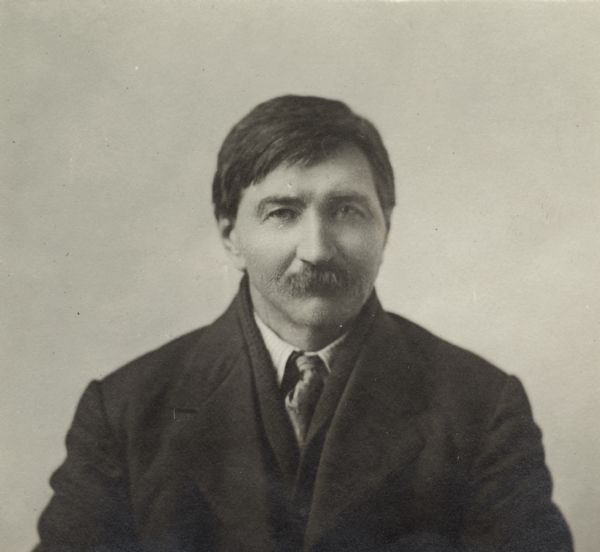 Quarter-length portrait of unidentified man with a moustache, wearing a jacket, shirt and a tie.