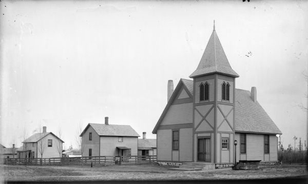 Church building and two frame houses.