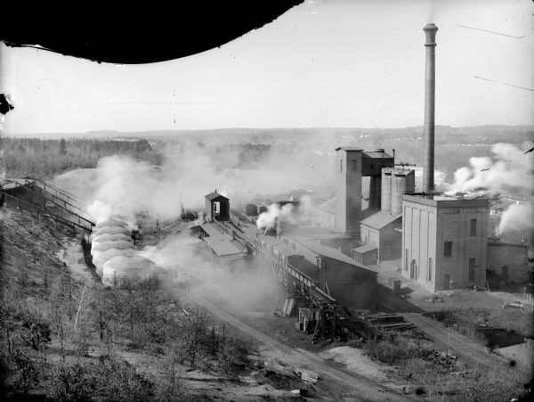 View down hill of York Iron Works. On the left are charcoal kilns, and in the far background is the town.