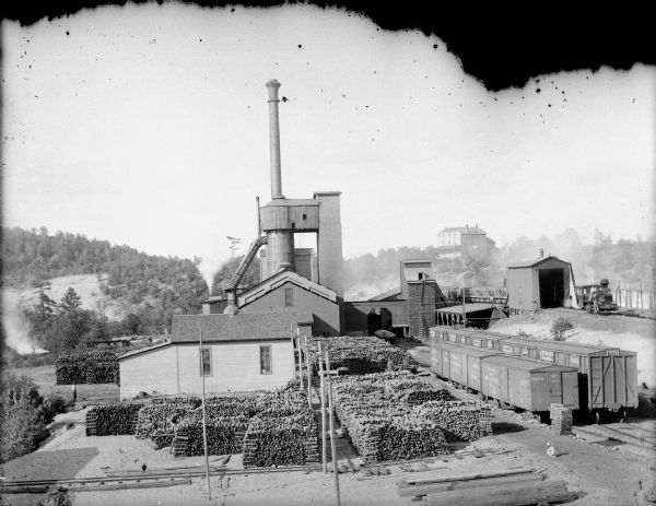 Elevated view of York Iron Works with a view of the blast furnace and pig iron stock piles. The boardinghouse is visible on the hill in the far background.