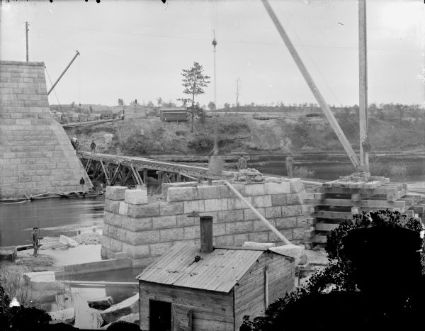 Elevated view of a construction site of a bridge across the cutoff on the river.