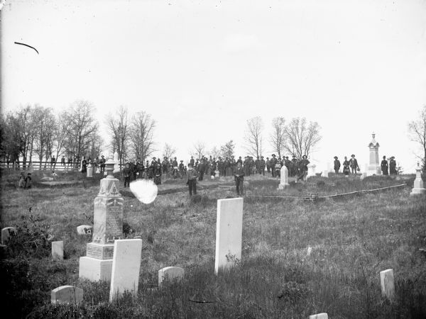 Large group posed standing in a cemetery, possibly Hixton or Schlechterville.	