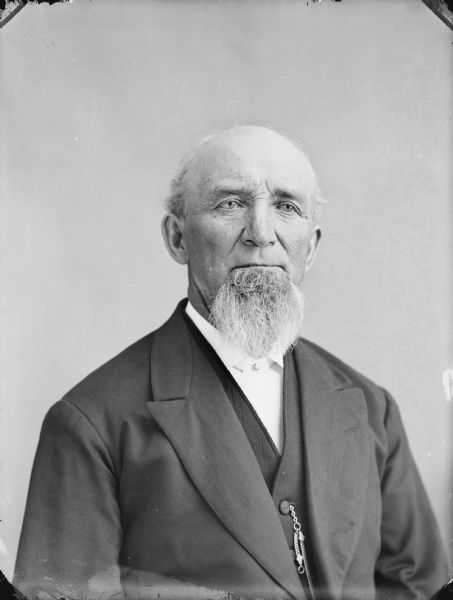 Quarter-length studio portrait of a man with a beard.