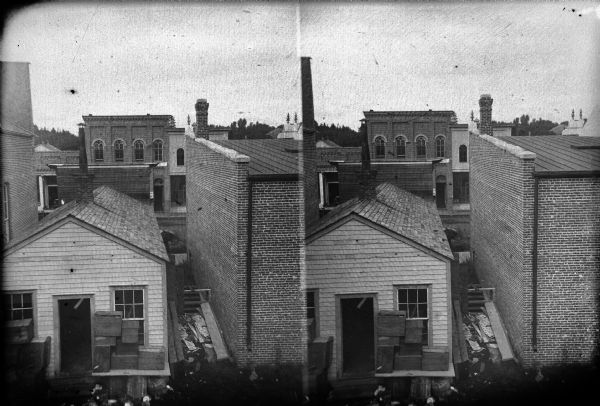 Elevated stereograph view of Black River Falls, between First and Second Streets, looking north across Main Street.