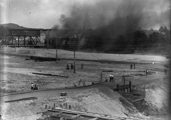 Elevated view of the fire at the McGillivray factory, with onlookers in the foreground.