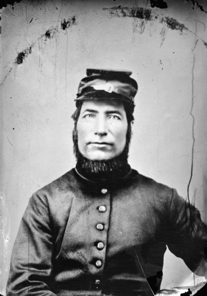 Copy photograph of a studio portrait of a Civil War era soldier.
