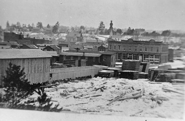 Copy photograph of Black River Falls. L & M Association lumber yards is identified in the foreground.