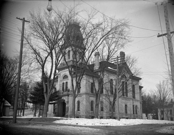 Exterior portrait of the Jackson County Courthouse, surrounded by snow. The courthouse was built in 1878 and is located on the northwest corner of Main and Third Streets.