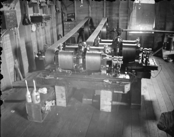 View looking down at machinery inside a building. Identified as the interior of a powerhouse, showing the generator.