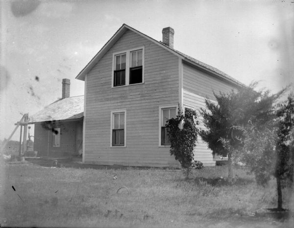 Wooden House with Well | Photograph | Wisconsin Historical Society