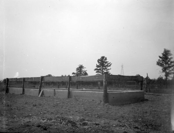 A large water tank for cattle. Identified as the water tank owned by C. L. MacDonald.
