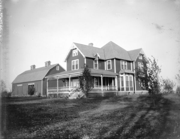 Exterior view of a large two-story wooden house. Identified as a house on Mosley Creek in Monroe County.