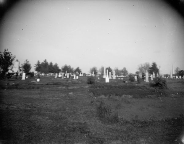 View towards a cemetery in the distance, and identified as the Black River Falls Cemetery.