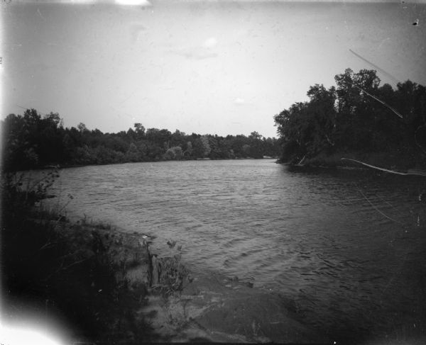 Outdoor view of a wide river. Location identified as the Black River.