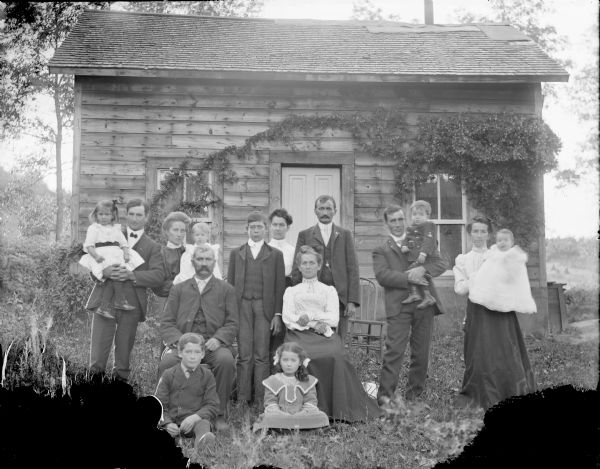 Outdoor group portrait of the extended William Jay family at their Town Creek home. Identified from left to right, standing in the back row: (unidentified male) Jay, holding his daughter, (unidentified female) Jay, holding her daughter, Ralph Jay, Lizzie Jay, John Jay, (unidentified male) Jay, holding his child, (unidentified female) Jay, holding her child. Sitting, center: William Jay and Mrs. William Jay. Sitting on ground: Ed Jay and Sadie Jay. 	

