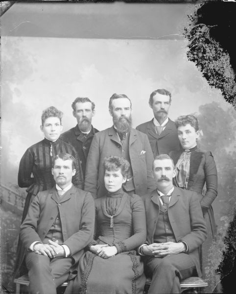 Studio portrait  of a group of five men and three women.