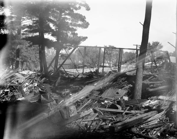 View of a bridge damaged by the 1911 flood. Debris is scattered in the foreground.