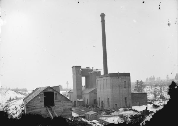 Elevated view of the York Iron Mine. A group of men are standing by the main building.
