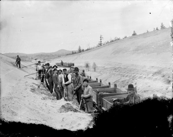 Elevated view of workmen building the main railroad line from Black River Falls to Vaudreuil.